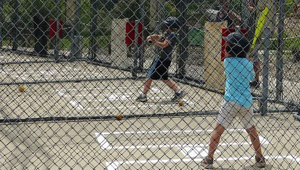 Batting cages with multiple pitch speed options